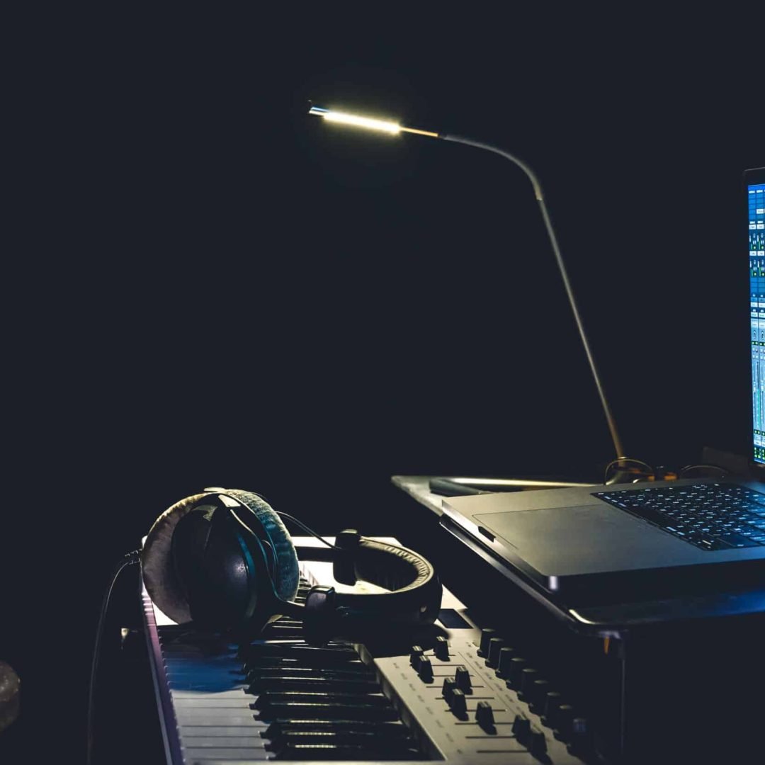 MIDI keyboard, headphones and a laptop with a special program for creating music, copy space.